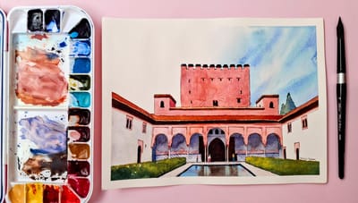 Bright watercolour painting of the Court of the Pool at the Alhambra, Granada by Emma Bolton. Watercolour palette and brush on a pink background.