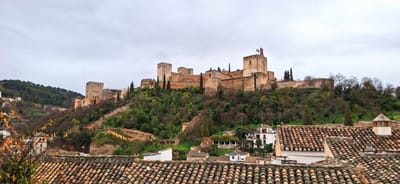 A view of the Alhambra, Granada surrounded by forest from the Albaicín.