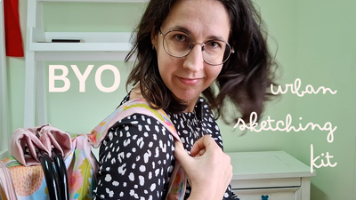 Bring your own urban sketching kit. Me holding my urban sketching backpack, which is pink and covered in large flowers, and tossing my dark brown hair. 